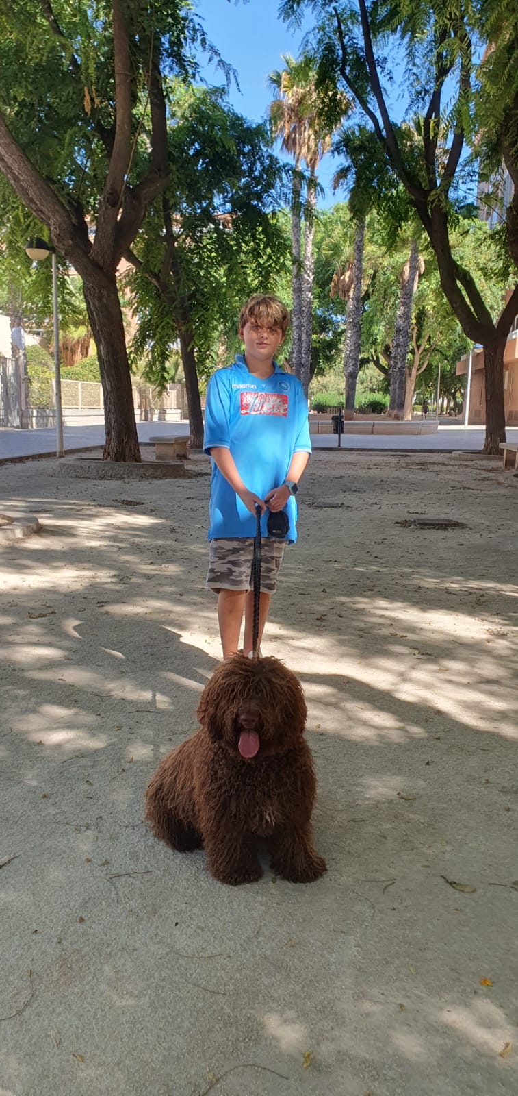 Alfredo with a happy dog at the park
